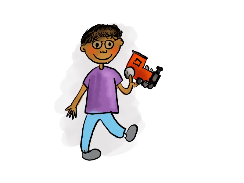 A little boy holding a toy train